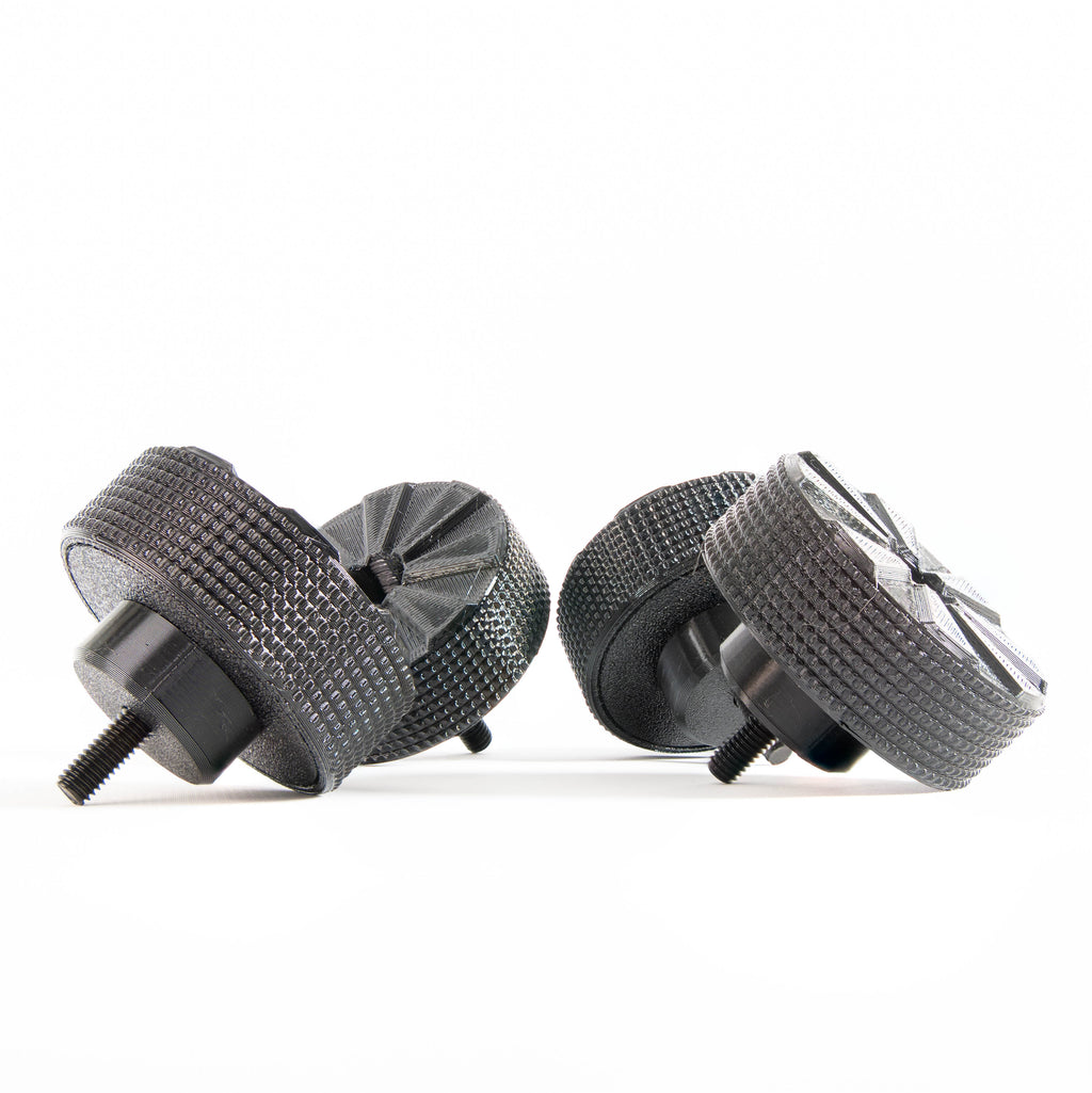 Bottom view of SpinCandy isolation feet showing water-channeling tread pattern. Designed to prevent hydroplaning and improve skid resistance in real-world environments like clubs, parties, or living rooms.