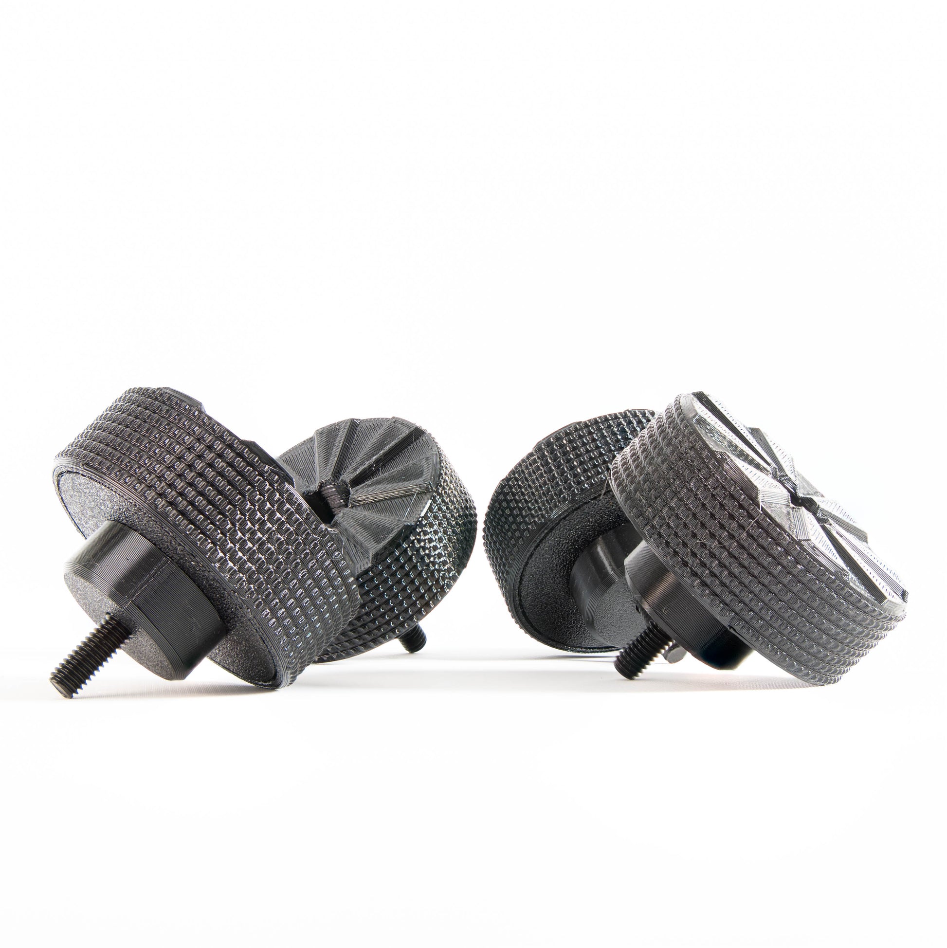 Bottom view of SpinCandy isolation feet showing water-channeling tread pattern. Designed to prevent hydroplaning and improve skid resistance in real-world environments like clubs, parties, or living rooms.
